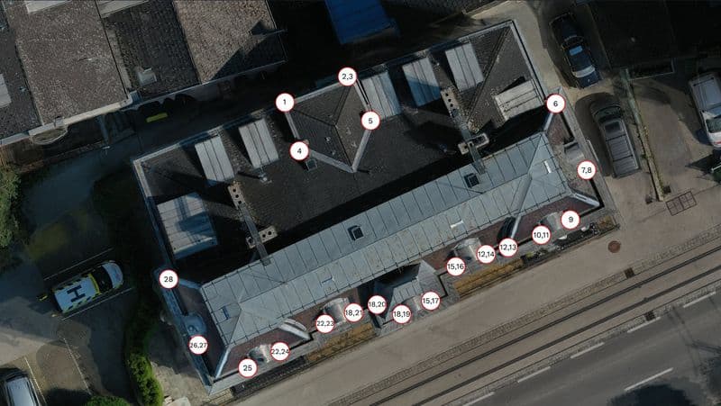 Tablet displaying drone footage of a roof